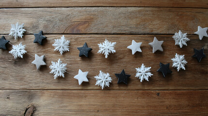 Garland of stars and snowflakes arranged on rustic wooden boards