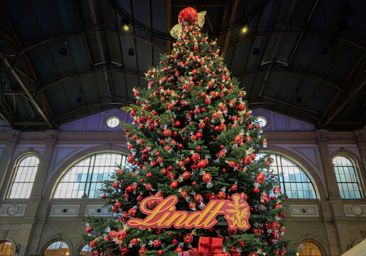 Iconic Lindt Christmas tree with red chocolate decorations, Zurich Hauptbahnhof