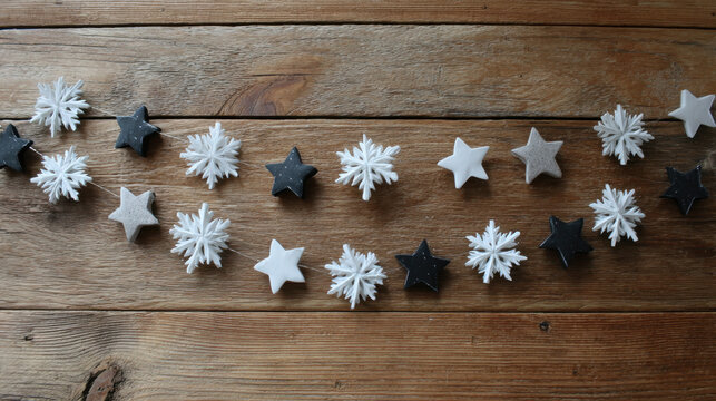 Garland of stars and snowflakes arranged on rustic wooden boards - Powered by Adobe