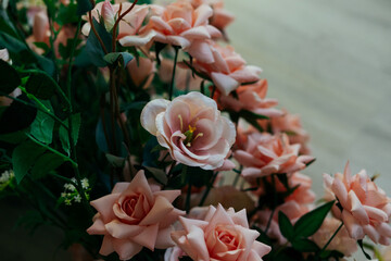 a floral arrangement made of environmentally friendly materials for the interior of a festive event, wedding, or presentation. A photo area with artificial roses