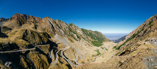 Epic mountain panoramic view of Transfagarasan Highway winding through vast Fagaras Mountains in Romania.