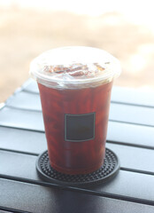 Iced black coffee on the camping table