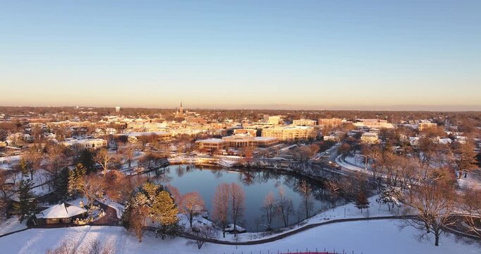 sunset over the river Aerial Winter View of Downtown Naperville and the Snow-Covered Riverwalk&rdquo;