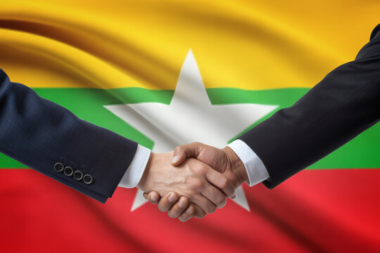 International partnership with Myanmar shown in handshake for successful business collaboration and global economic growth and cooperation - Powered by Adobe