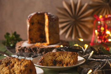 Served Slice of Panettone with Blurred Holiday Cake Backdrop