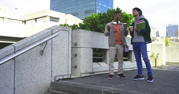 Diverse friends holding coffee noticing architecture, checking phone and descending plaza stairs