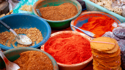 Bowls of spices for sale at a market stall in Luang Prabang, Laos