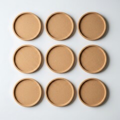 Arrangement of neutral cork coasters in grid formation on white surface