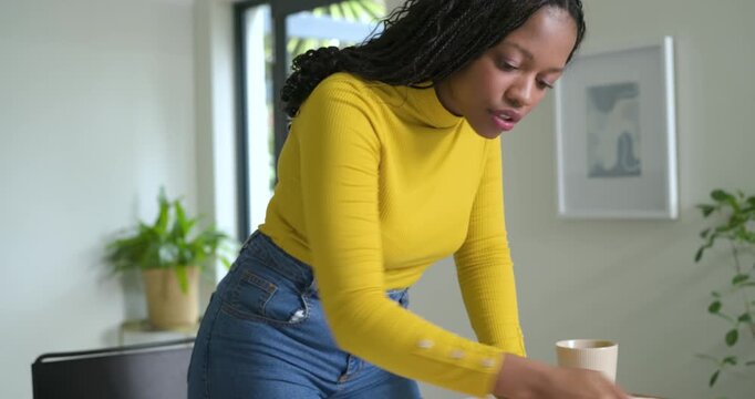 Diverse coworkers reaching for marker sketching paper at desk while swiping tablet for planning