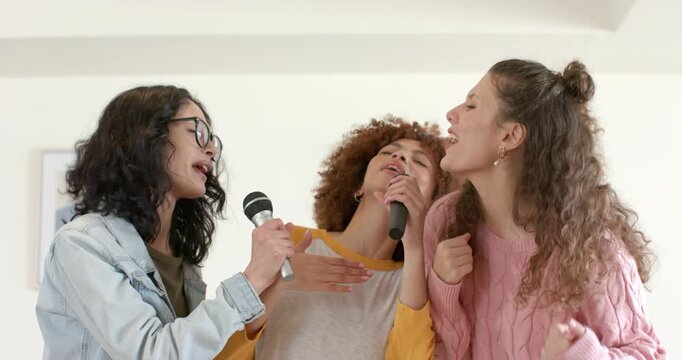 Diverse female friends responding to left mic raise, singing lead backup harmonies in living room