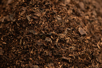 Soil mixed with compost and dry leaves background.
