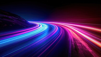 Illuminated streaks of light curve along a road in a dynamic, colorful nighttime scene