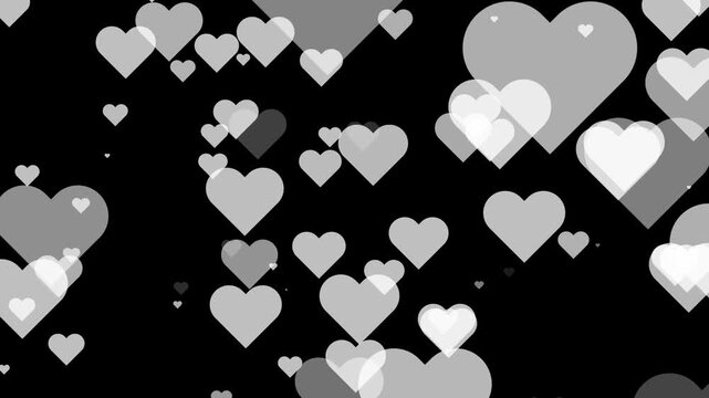 Numerous translucent white and grey hearts floating against a black background love romance