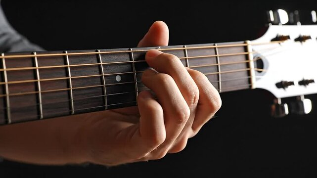 Guitarist's Hand Playing Acoustic Guitar, Close-Up on Frets