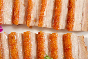 A top down view of a plate of crispy pork belly.