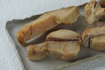 Indonesian traditional food, ikan asin jambal or salted fish on plate. Dried fish, preservative, uncooked, salty fish