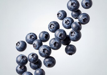 Fresh Ripe Blueberries Falling and Floating in Dynamic Movement on a Bright Light Background