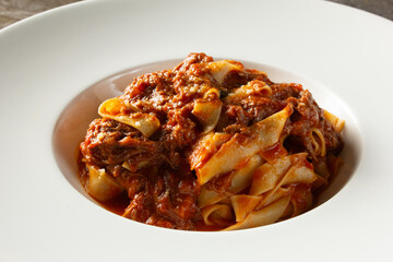 A closeup view of a plate of tagliatelle ragu.