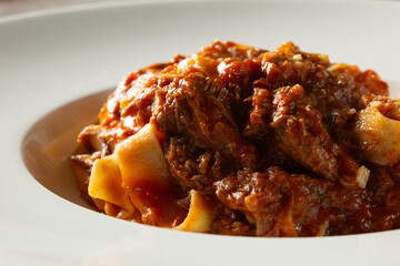 A closeup view of a plate of tagliatelle ragu.