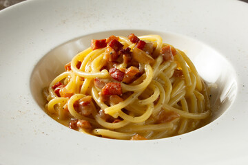A view of a plate of spaghetti carbonara.