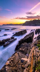 Coastal scene with dramatic rock formations under a colorful sunset