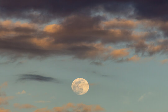 The full moon in the blue sky with clouds, 