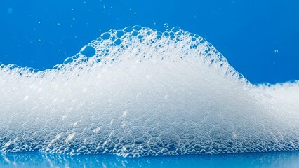 Fluffy white soap bubbles cascade against a vibrant blue backdrop, creating a clean, refreshing feel for hygiene products or sparkling cleaning solutions promotion