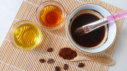 Natural coffee face mask. Coffee face mask homemade. Ingredients for natural coffee mask and scrub, with honey and olive oil. Copy space for your text.