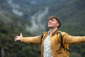 Man breathing deeply and embracing nature on eco trip
