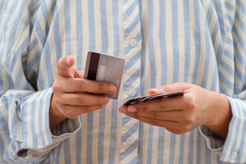 Woman holding credit cards and he is choosing a credit card to pay and spend Payment for goods via...
