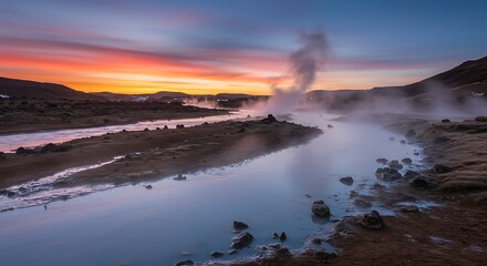 Scenic, tranquil panorama showing a river with mist rising, framed by dark rocks, under a vibrant sunset