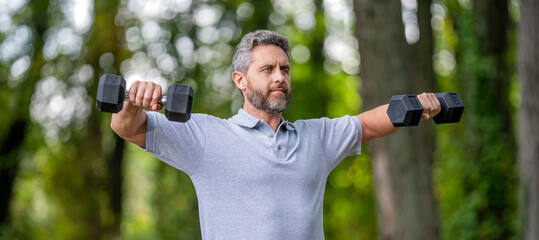 Biceps muscle. Strong triceps. Man exercising with dumbbell. Man athlete lifting dumbbell. Strong man do sport training. Outdoor workout. Sport athlete man with dumbbell. Healthy lifestyle