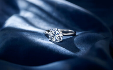 Cinematic diamond engagement ring on dark blue draped silk fabric, elegant luxury jewelry background, shiny solitaire gemstone close up, macro platinum wedding band, soft satin texture, sparkling.