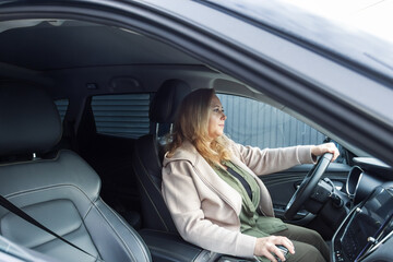Naklejka premium Middle-Aged Caucasian Woman Driver. Female Commuting on a Road Trip or Daily Journey.