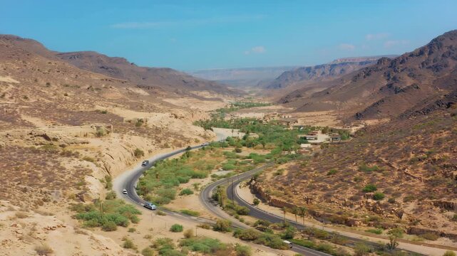 Aerial Drone View of Winding Road Through a Rugged Valley in a Semi-Arid Landscape 4K