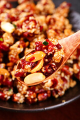 Crispy Red Chili Chinese Dish with Peanuts on Wooden Spoon