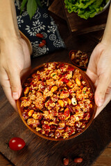 Hands Holding Crispy Chinese Fried Rice with Peppers and Peanuts