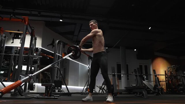 Workout training. Athletic man performing landmine exercises with barbell. Strength and fitness. Muscular sportsman in sport gym do landmine exercise. Sport sportsman with barbell landmine in gym