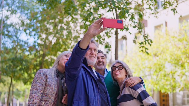 Group of cheerful seniors taking a selfie with a smartphone