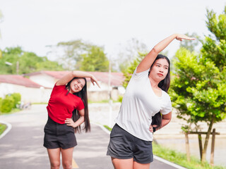 Fitness woman couple light exercise happy stretching outdoor winter workout in morning routine park holiday. Healthy lifestyle people self care wellness planning new beginnings new year transformation