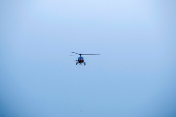  helicopter is flying on isolated blue sky