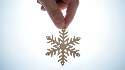 hand holding a wooden christmas ornament