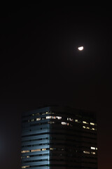 night view of the city and building with moon