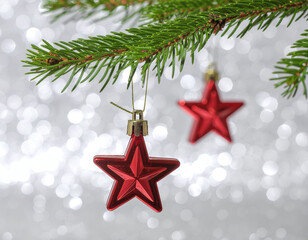 Red Star Christmas Ornaments Hanging on Pine Branch with Bokeh