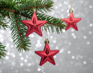 Red Star Christmas Ornaments Hanging on Pine Branch with Bokeh