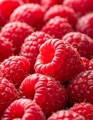 Close-up shot of several vibrant red berries, tightly packed together, showcasing detailed textures and subtle shadows. The focus is on the rich color