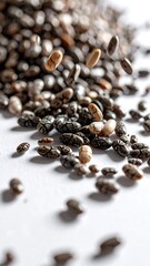 Close-up shot of small, oval-shaped seeds with a variety of dark and light speckled coloration, scattered and falling. Focus on textures