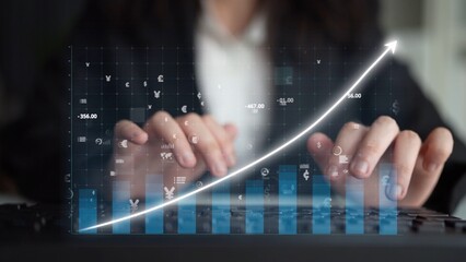 A business professional engages in data analysis on a keyboard, surrounded by a digital graph illustrating growth. The workspace conveys innovation and productivity. Copula