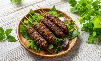 Appetizing mouthwatering shot of a Seekh Kabab made with minced chicken or Mutton keema, served in what plate.. bakra, ground, goat, mince. arab, middle east.