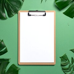 Top-down view of blank clipboard surrounded by green foliage